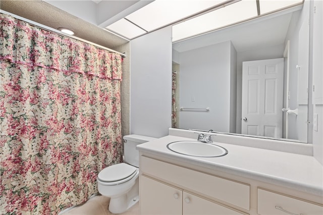 bathroom with vanity, toilet, and walk in shower