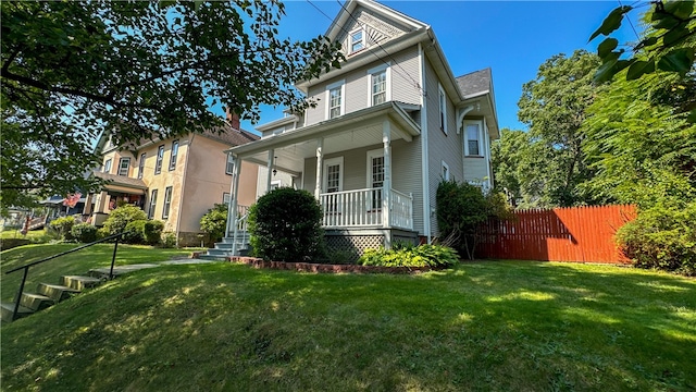 view of front of home with a porch and a front yard