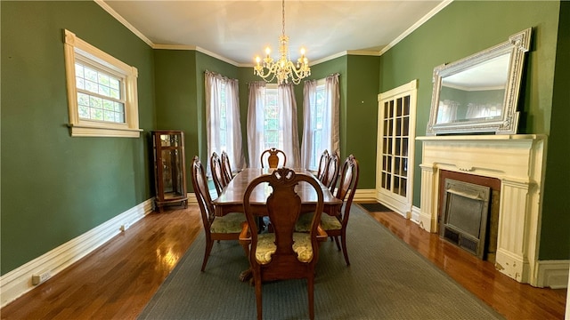 dining space featuring a notable chandelier, dark hardwood / wood-style floors, and ornamental molding