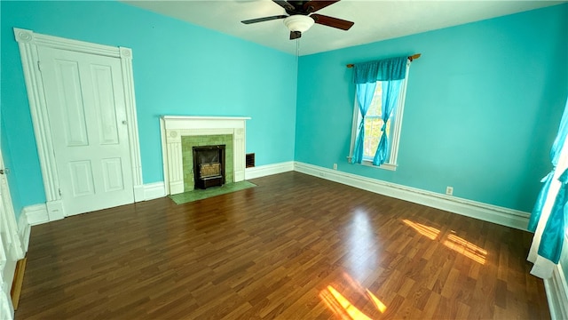 unfurnished living room with ceiling fan and dark wood-type flooring