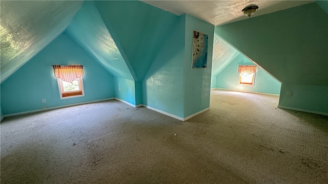 bonus room with carpet and vaulted ceiling