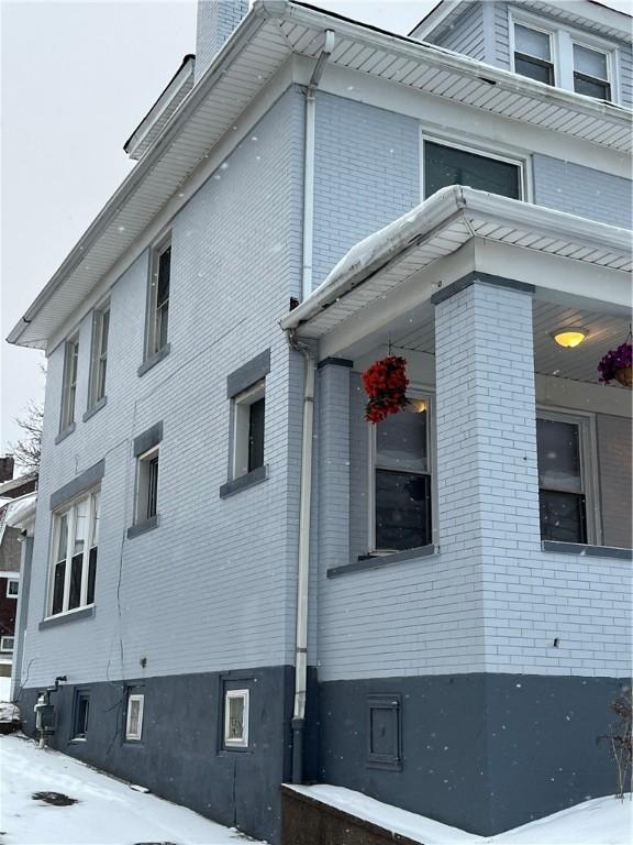 view of snow covered exterior featuring covered porch