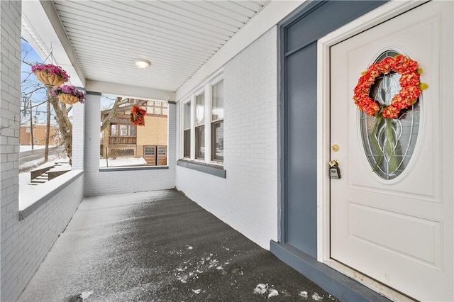 view of exterior entry with covered porch