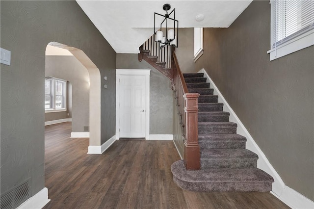 stairs featuring wood-type flooring