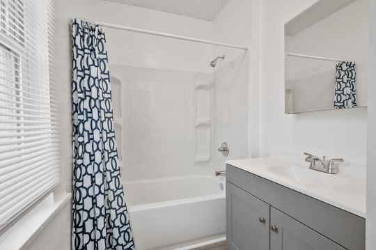 bathroom with vanity and shower / bathtub combination with curtain