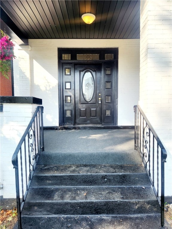 view of exterior entry with covered porch