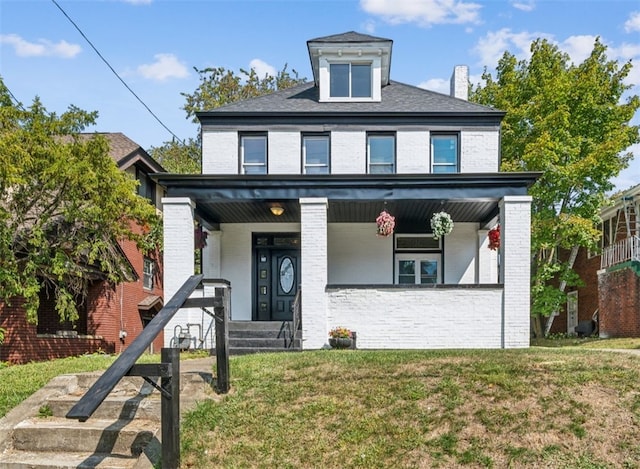 view of front of home featuring covered porch and a front lawn