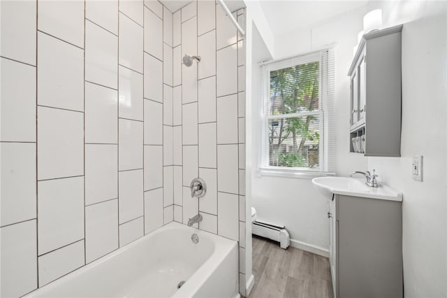 full bathroom featuring vanity, toilet, tiled shower / bath combo, and wood-type flooring