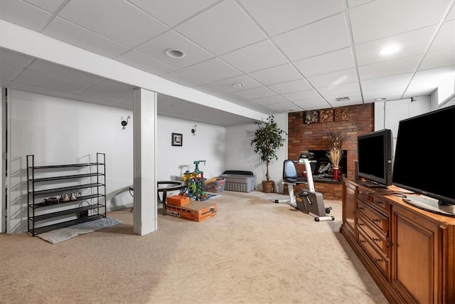 basement with a fireplace, carpet, and a drop ceiling