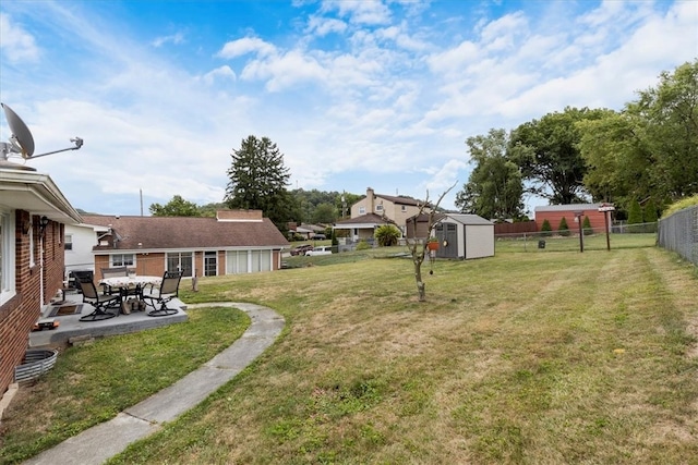 view of yard featuring a patio area and a storage shed