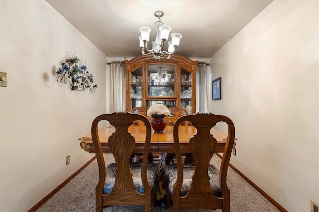 carpeted dining room with a notable chandelier