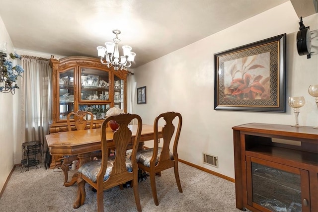 carpeted dining area with a notable chandelier