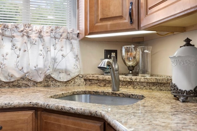 details featuring light stone counters and sink