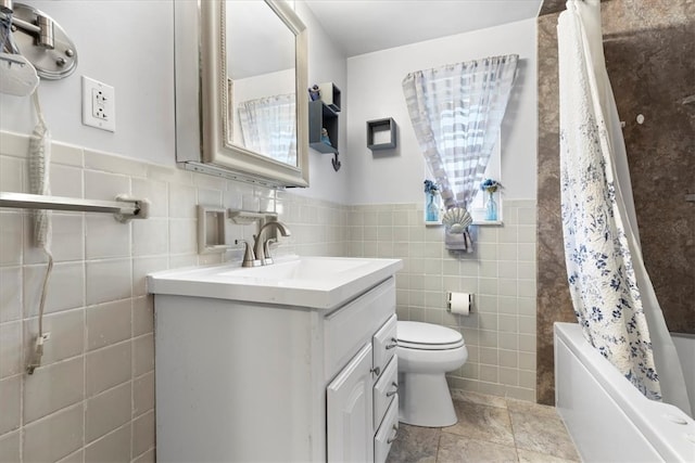 full bathroom featuring toilet, vanity, backsplash, tile walls, and shower / bath combination with curtain