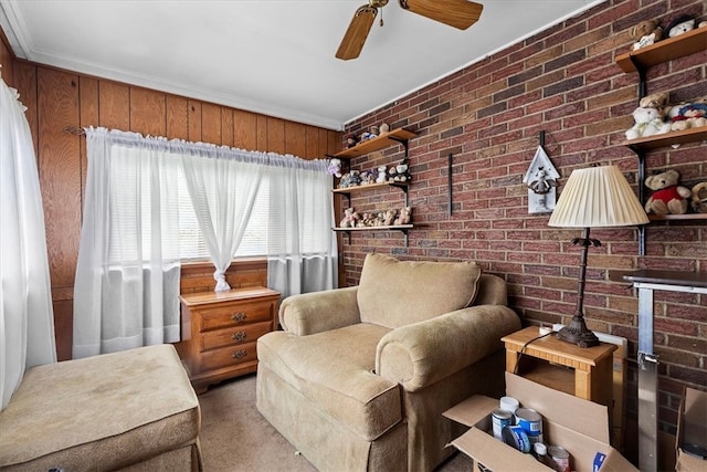 living room featuring ceiling fan, crown molding, light carpet, and brick wall