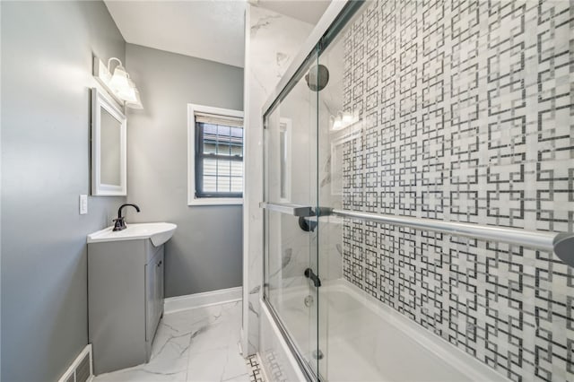 bathroom with shower / bath combination with glass door and vanity