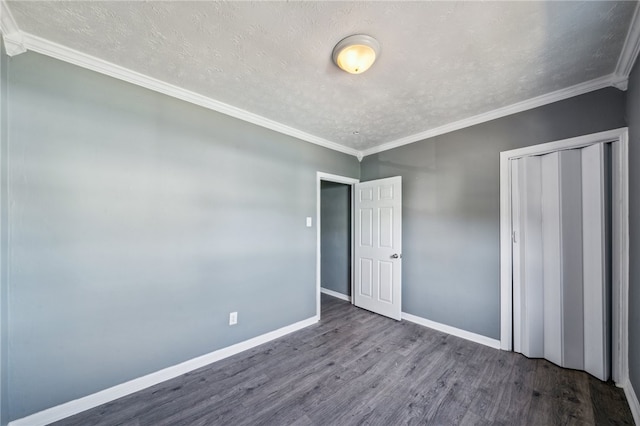 unfurnished bedroom featuring ornamental molding, a textured ceiling, and hardwood / wood-style flooring