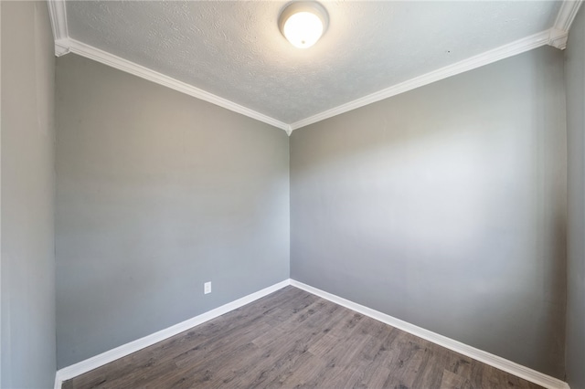 spare room featuring a textured ceiling, crown molding, and hardwood / wood-style flooring