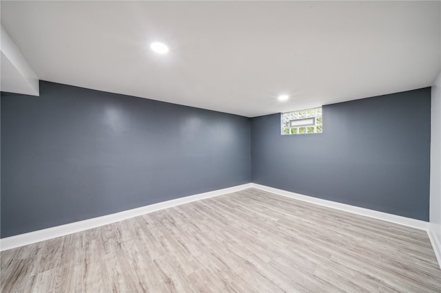 basement with light hardwood / wood-style flooring