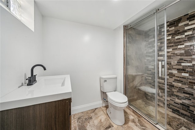 bathroom with vanity, toilet, and an enclosed shower