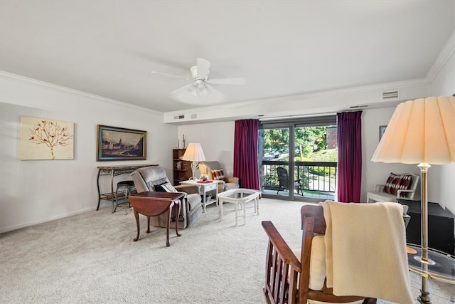 living room featuring ceiling fan, ornamental molding, and carpet floors