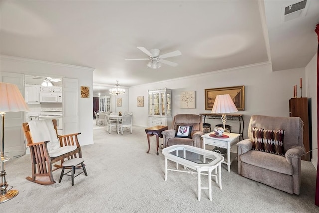 living room featuring light colored carpet, ornamental molding, and ceiling fan with notable chandelier