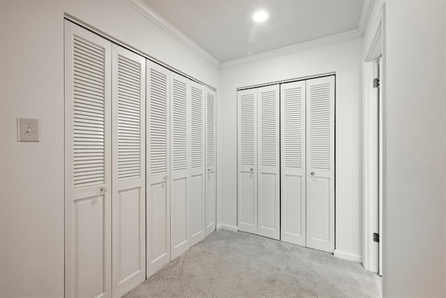 hallway with light colored carpet and ornamental molding