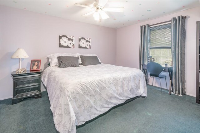 bedroom with dark colored carpet and ceiling fan