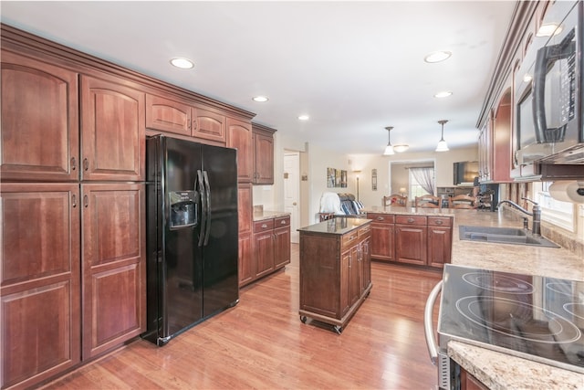 kitchen with sink, a wealth of natural light, light hardwood / wood-style floors, and black refrigerator with ice dispenser