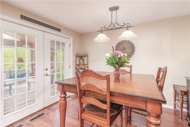 dining room with french doors and hardwood / wood-style floors