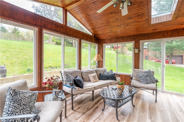 sunroom with lofted ceiling with skylight and a healthy amount of sunlight