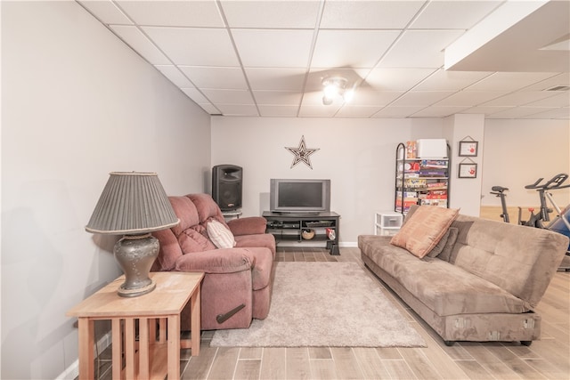 living room featuring hardwood / wood-style floors and a drop ceiling