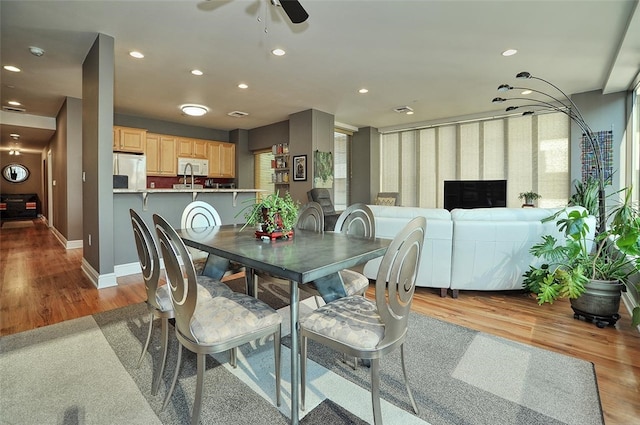 dining area featuring light wood-type flooring and ceiling fan