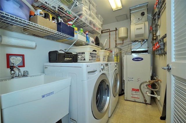 clothes washing area featuring washing machine and clothes dryer and sink