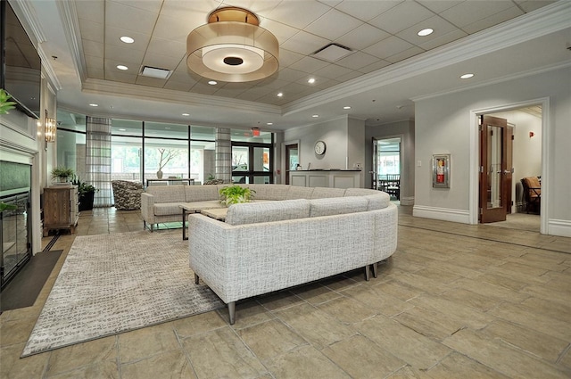 living room featuring floor to ceiling windows, a tray ceiling, and ornamental molding