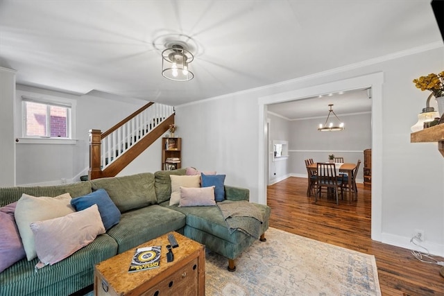 living room featuring crown molding, an inviting chandelier, and hardwood / wood-style floors