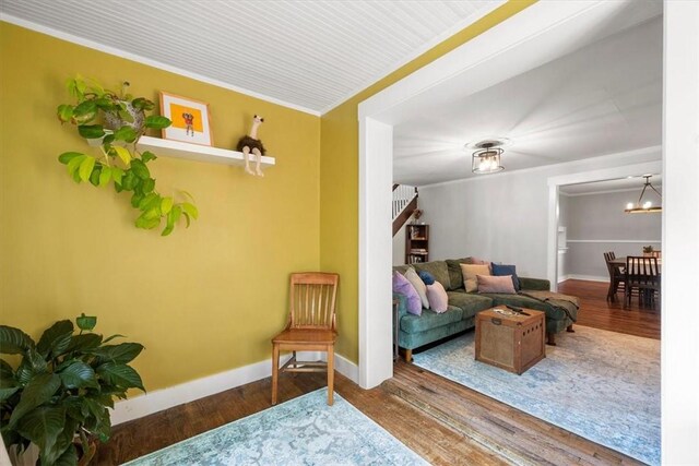 interior space with ornamental molding, a chandelier, and hardwood / wood-style flooring