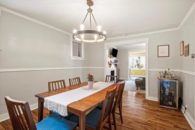 dining space with crown molding, a notable chandelier, and wood-type flooring