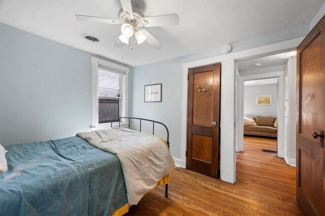 bedroom with ceiling fan and wood-type flooring