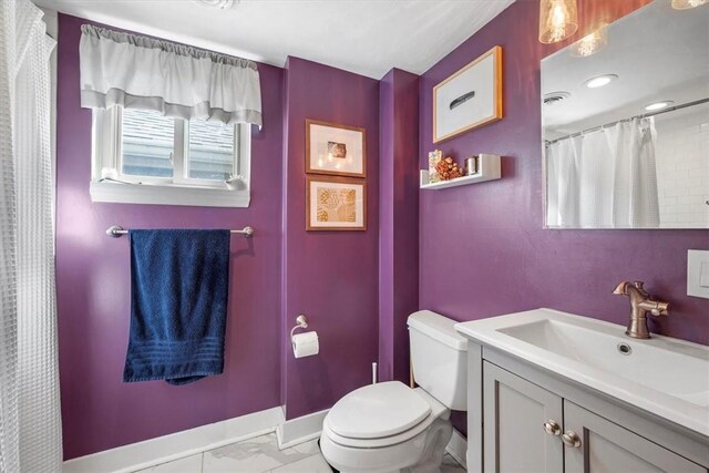 bathroom with vanity and toilet