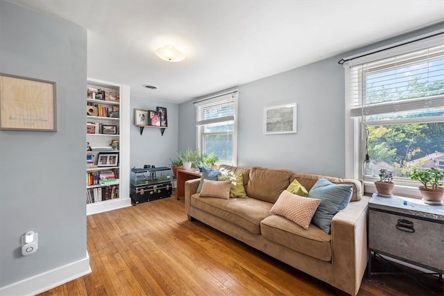 living room featuring a wealth of natural light and light hardwood / wood-style flooring