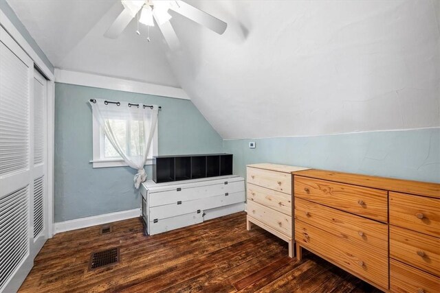 bedroom featuring a closet, ceiling fan, dark hardwood / wood-style flooring, and vaulted ceiling