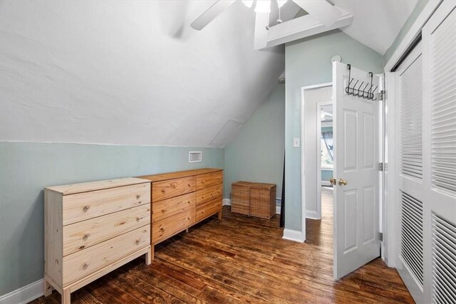 bonus room with lofted ceiling, dark wood-type flooring, and ceiling fan