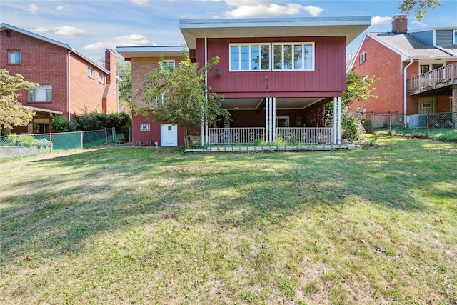 rear view of property featuring a yard