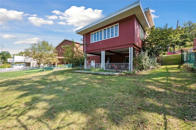 rear view of property with a lawn