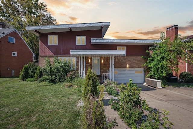 contemporary home with a lawn and a garage