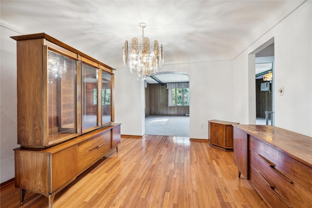 dining area featuring light hardwood / wood-style flooring and a chandelier