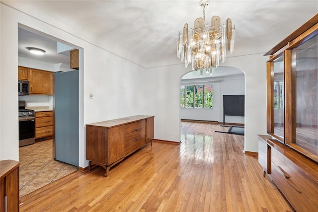 dining room featuring light wood-type flooring and a chandelier