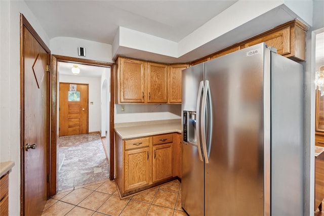 kitchen with stainless steel fridge and light tile patterned floors