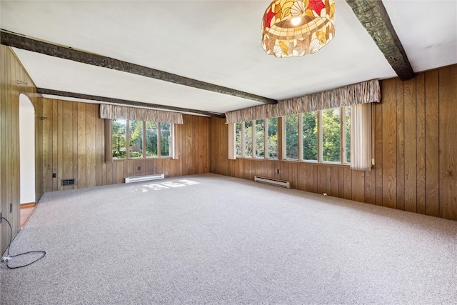 carpeted empty room with wood walls, a baseboard radiator, and beam ceiling